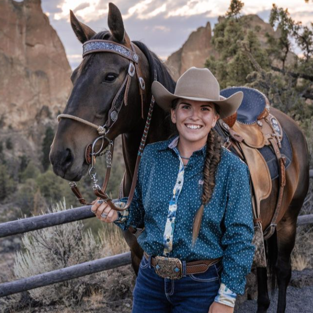 Cowgirl wit her horse and a western belt buckle